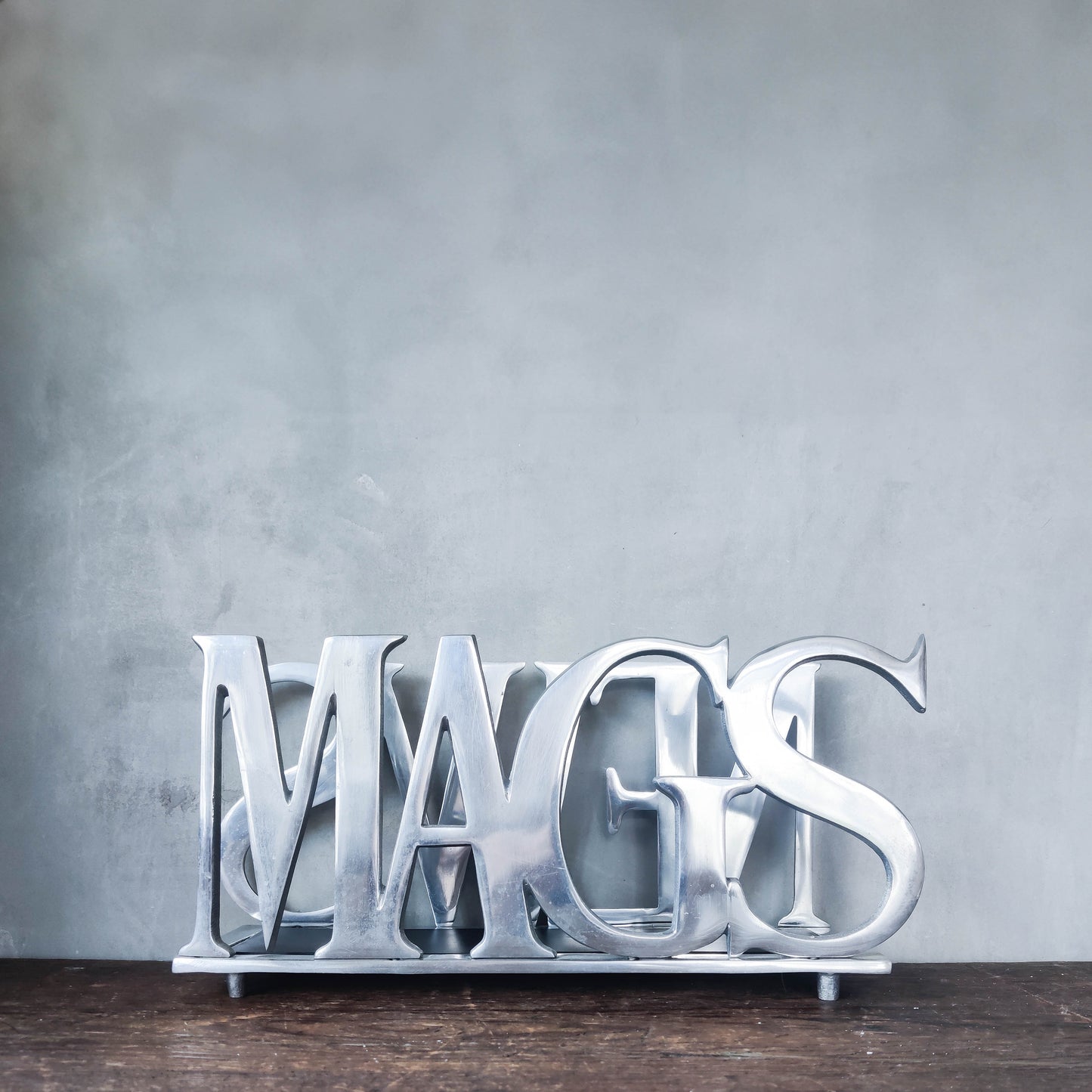 Vintage 00s cast aluminium metal magazine rack holder stand