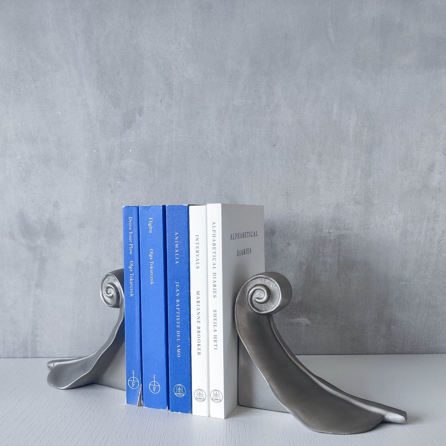 Vintage 00s cast aluminium swirl spiral scroll weighted sculpture bookends pair