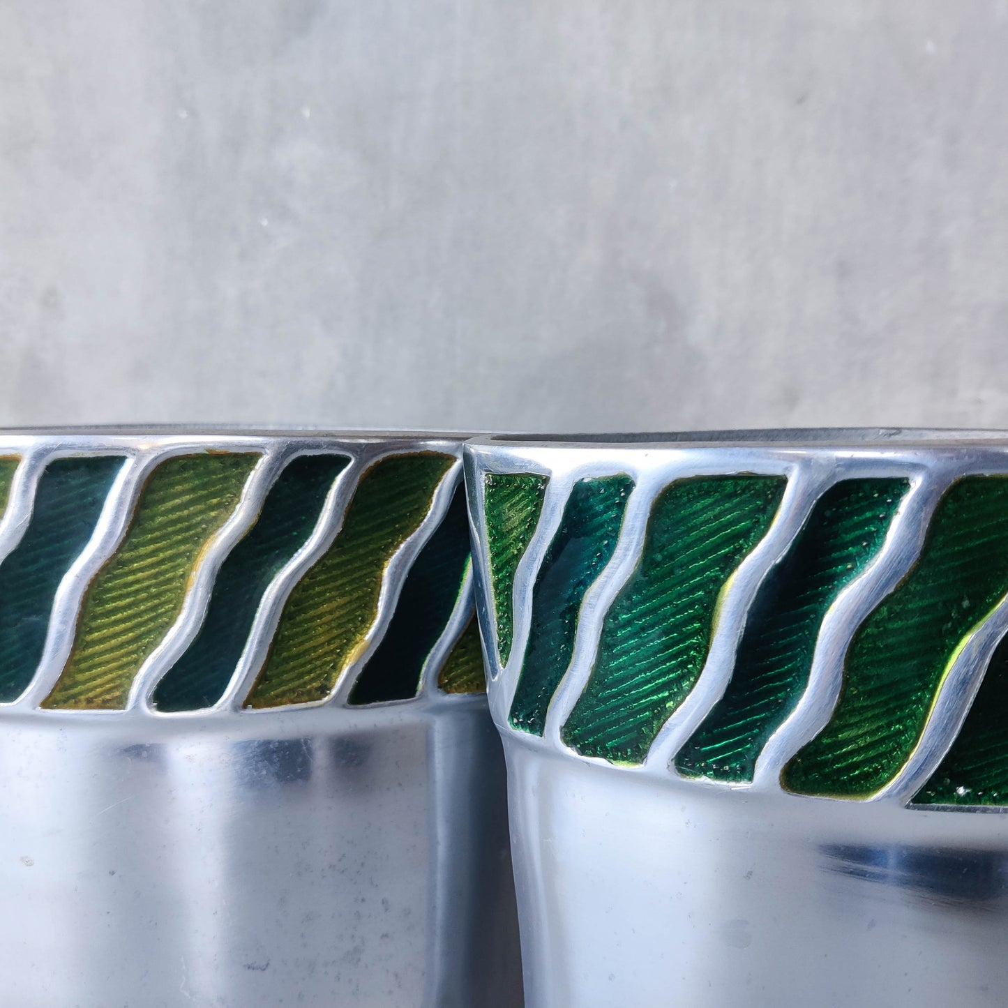 Pair of vintage 00s cast aluminium sculptural vases with green enamel wave inlay