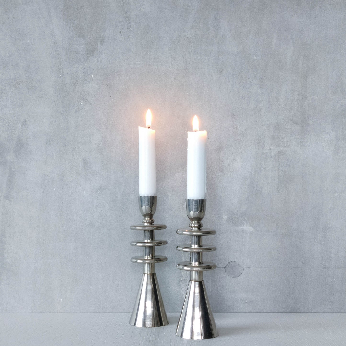 Vintage pair of chrome modernist form sculptural tiered candle holders