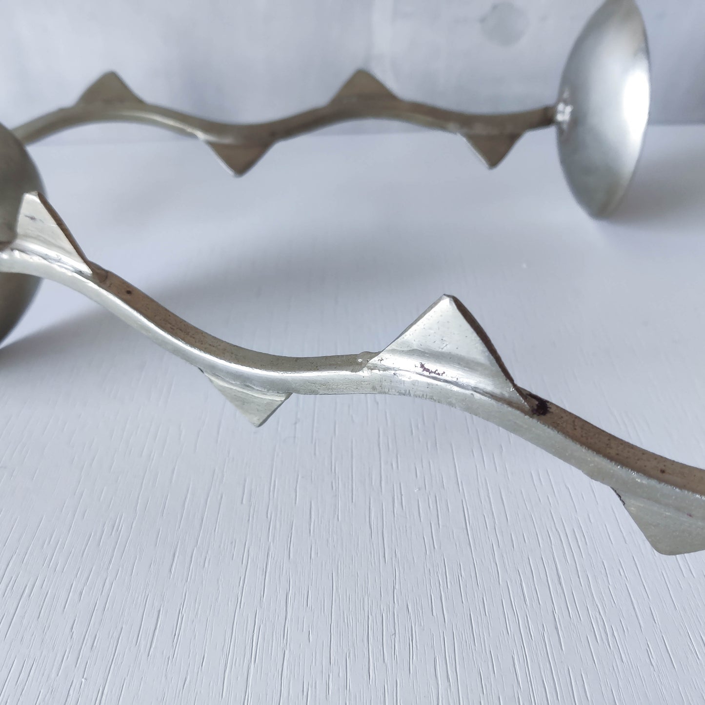 Pair of tall vintage sculptural wavy zigzag footed aluminium candle holders