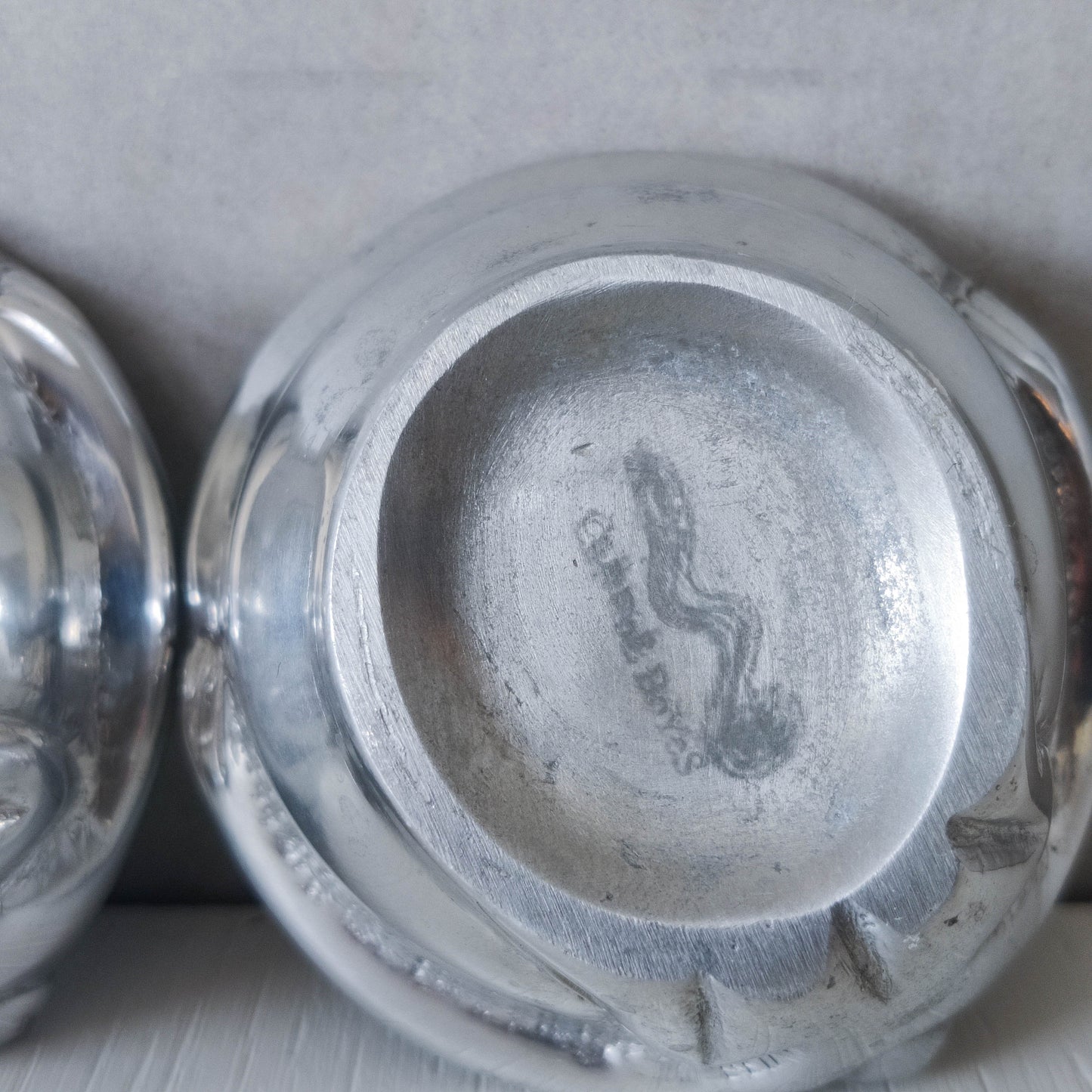 A pair of Carrol Boyes small figural cast aluminium bowls or tea light holders