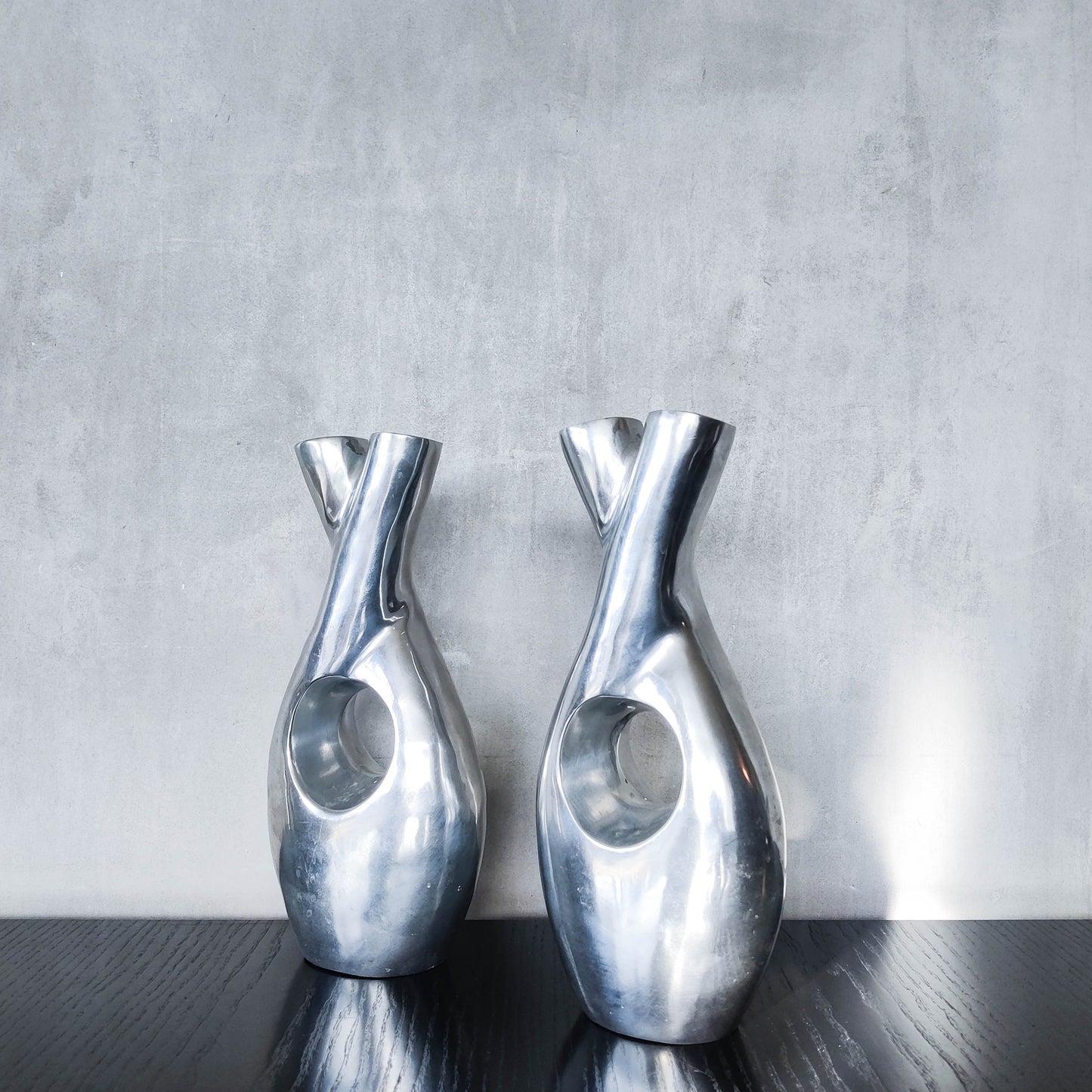 Pair of vintage cast aluminium sculptural donut twist vases