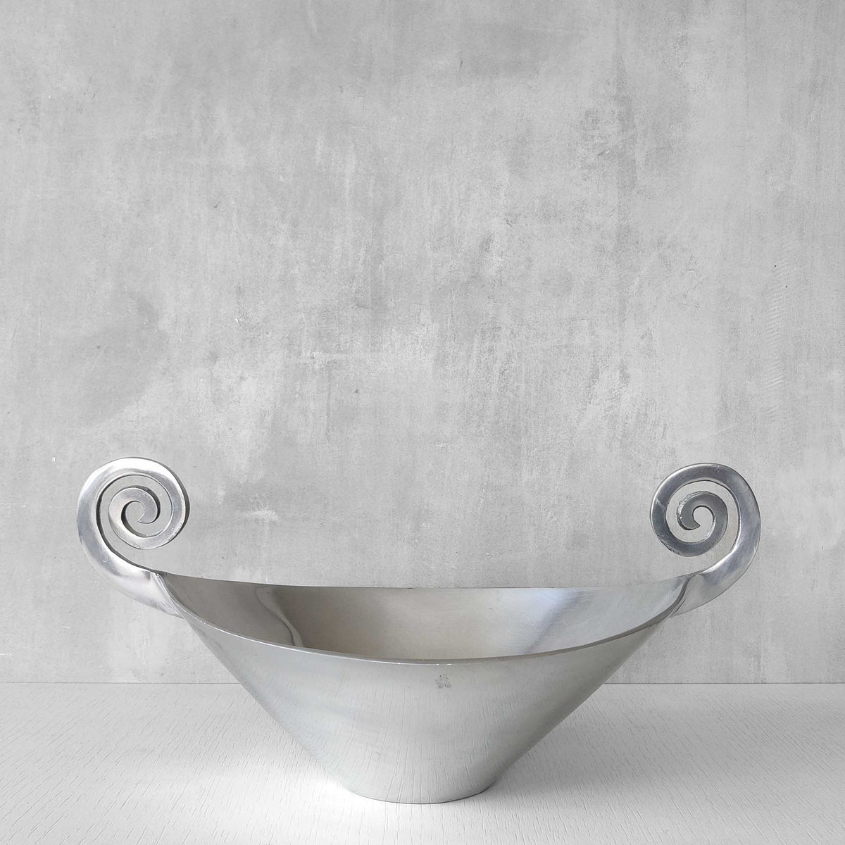 A 1990s cast aluminium centrepiece bowl with spiral handles