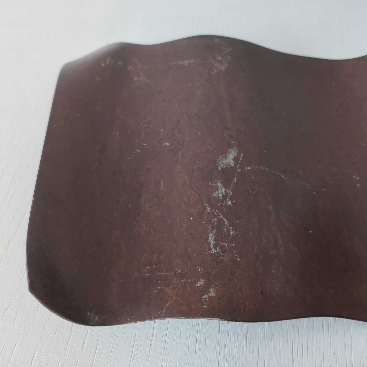 A large steel patinated wavy scrolled sculptural candle sconce