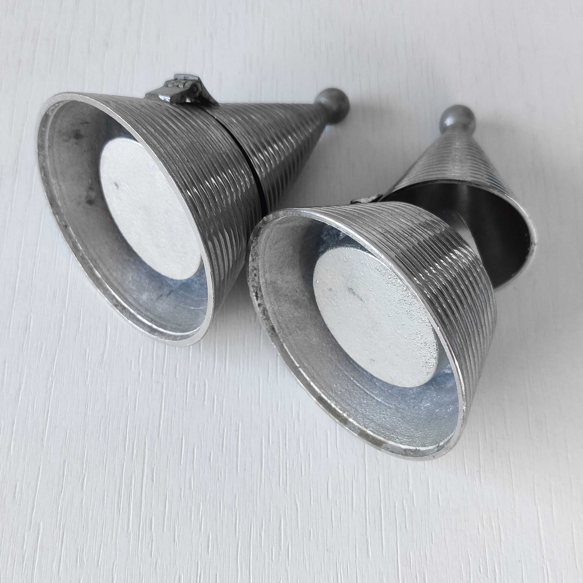 Pair of vintage conical ribbed cast metal tea light holders Aldo Rossi style