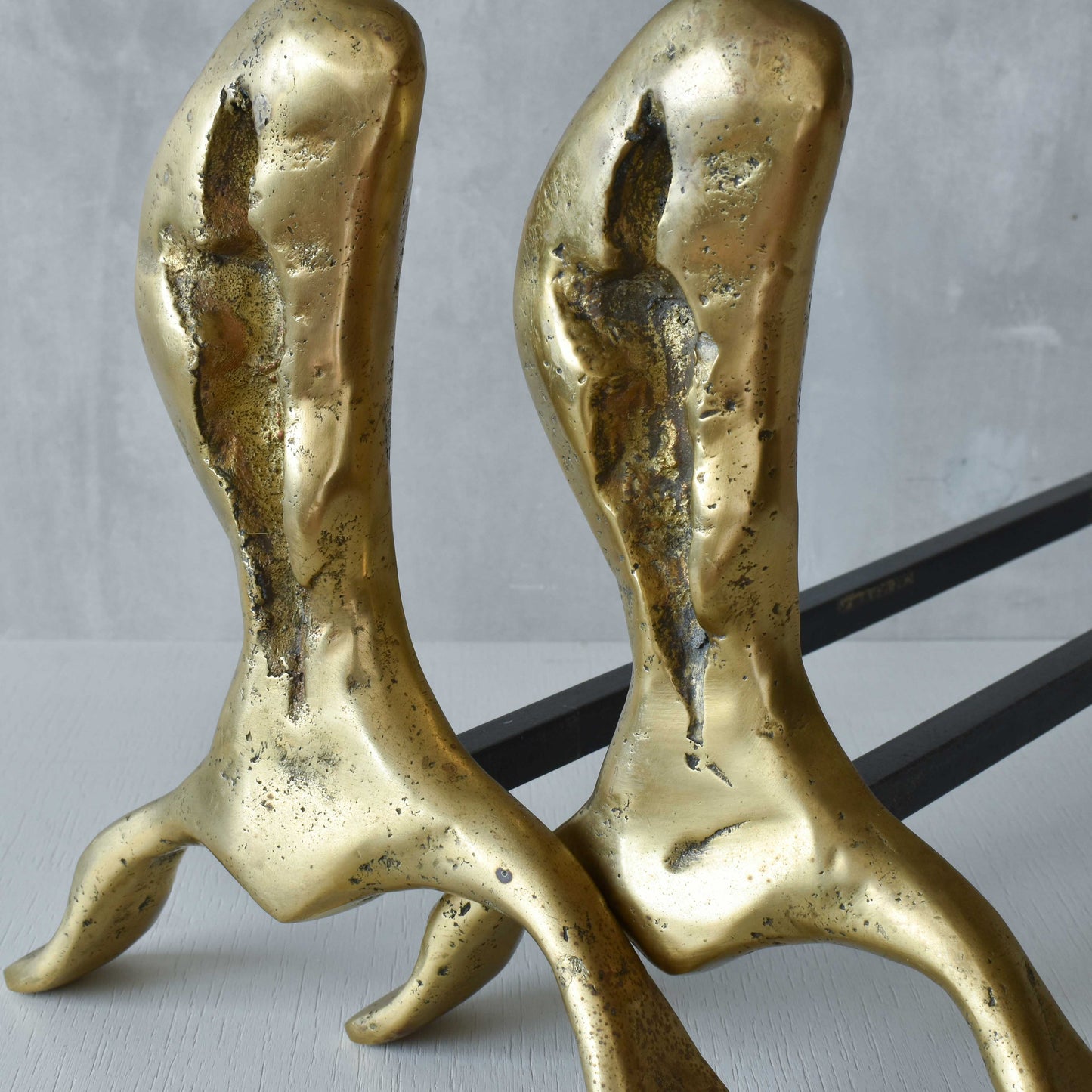 A David Marshall pair of organic brutalist sand cast brass sculptural fire dogs