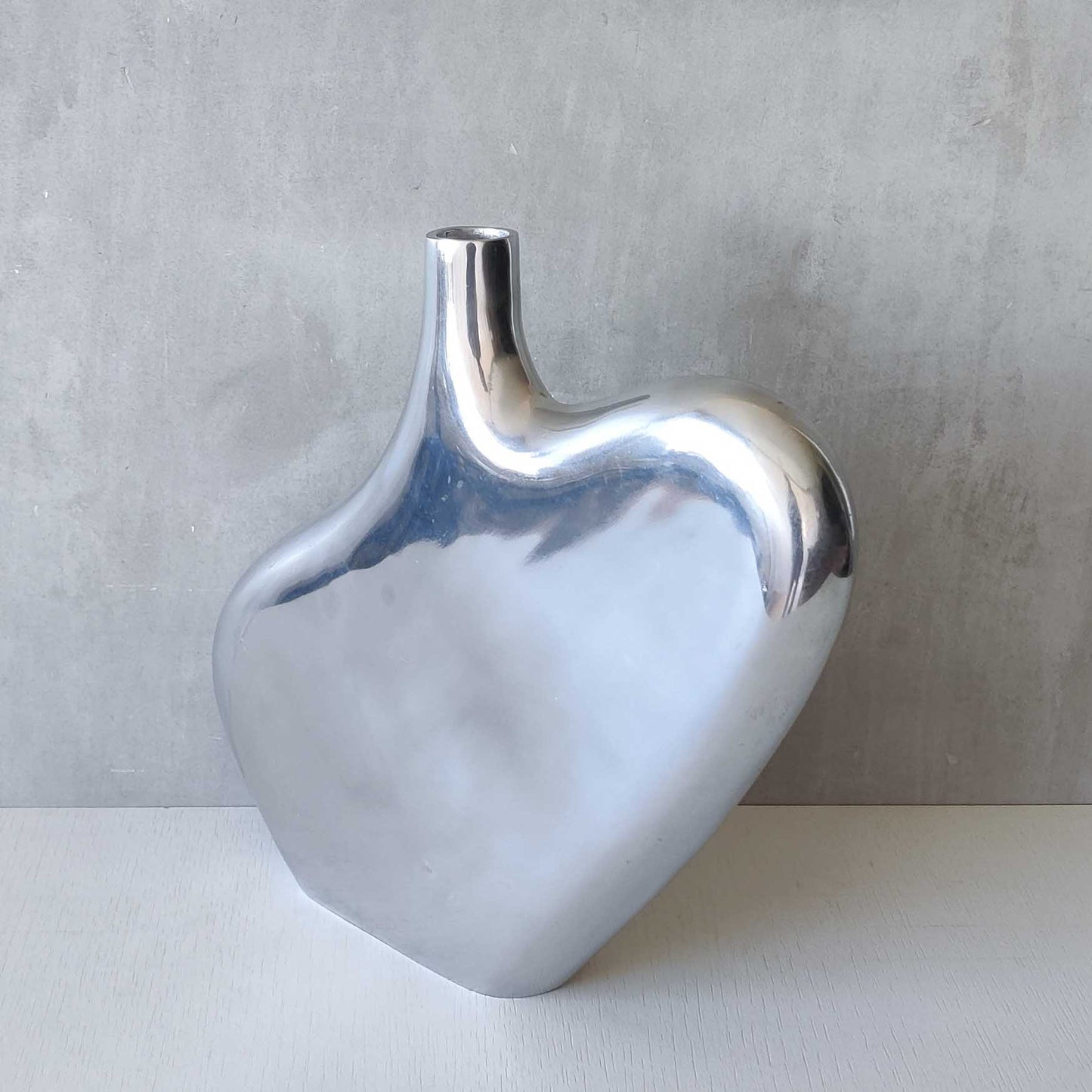 A large cast aluminium sculptural asymmetric vase