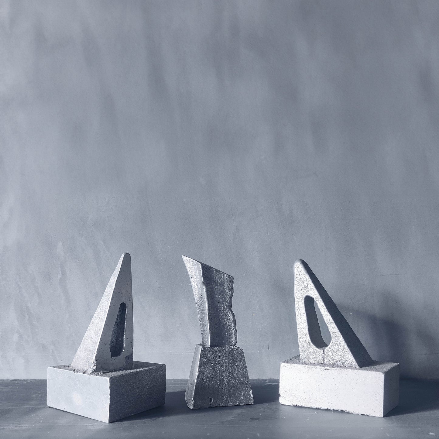 Trio of artist made abstract cast aluminium sculptures