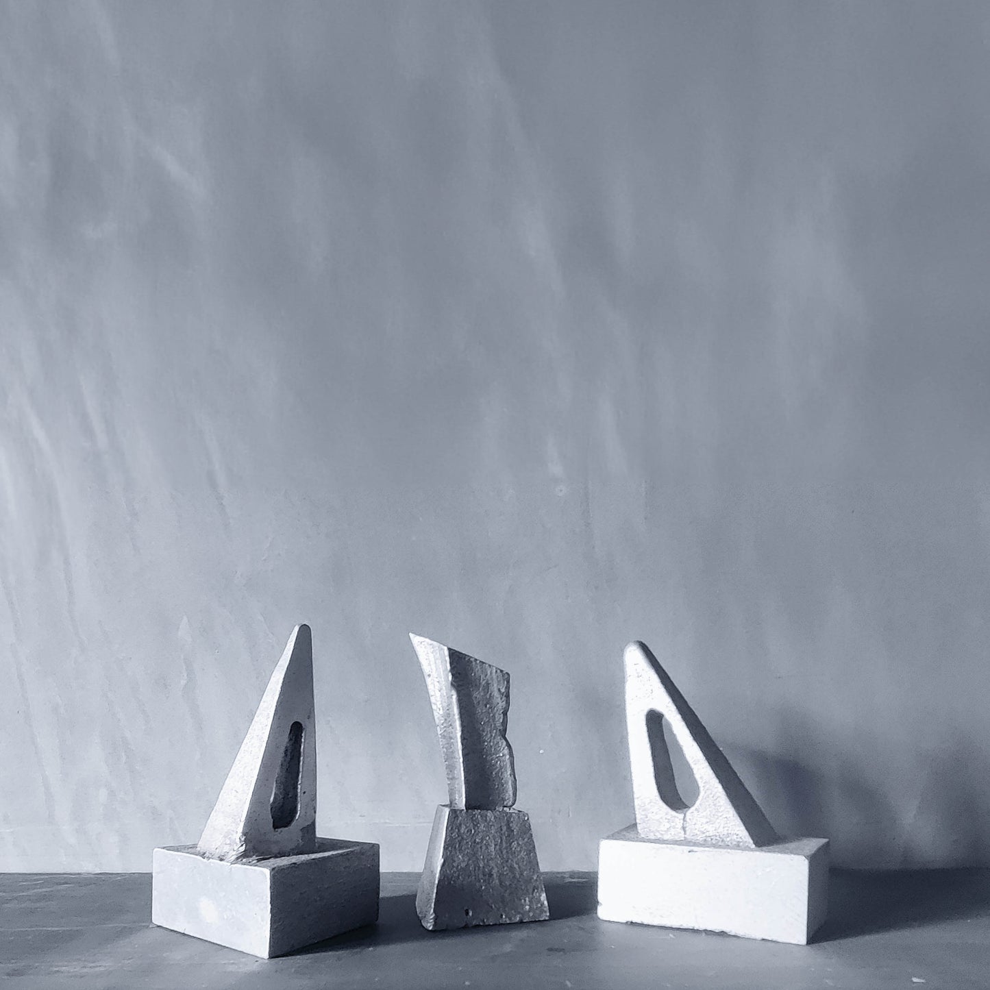 Trio of artist made abstract cast aluminium sculptures