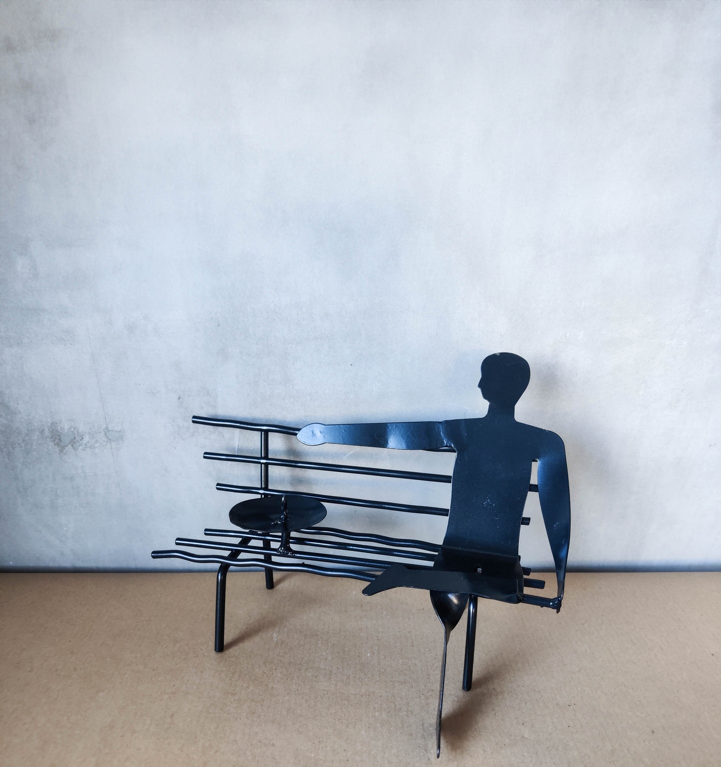 Surreal welded steel figure on bench candle holder 00s