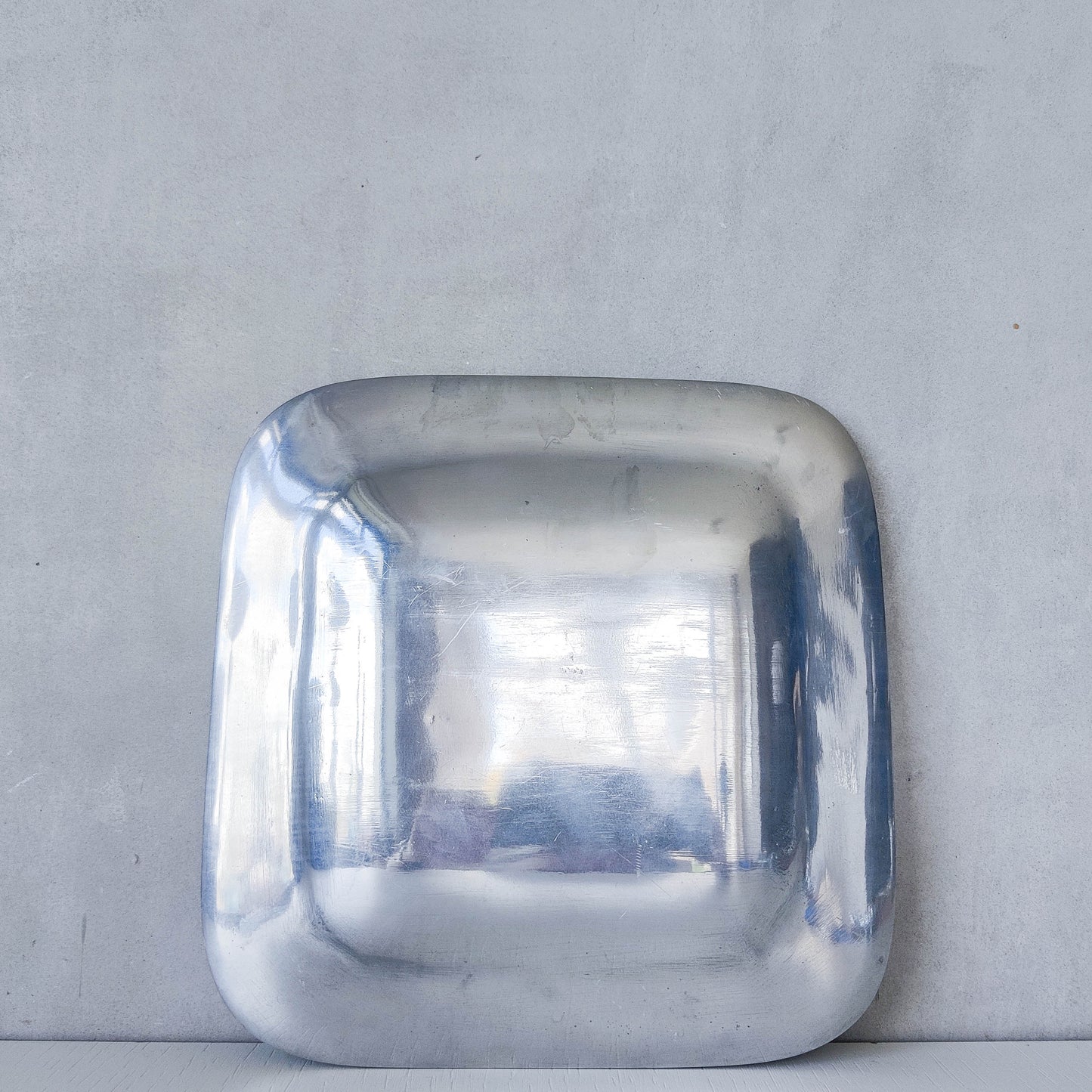 Vintage 1990s cast aluminium plate dish vide poche inlaid brass sun and fish motif