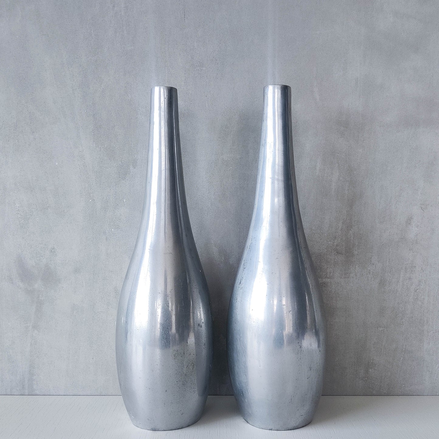Pair of vintage cast aluminium modernist style sculptural bottles vases vessels 41cms