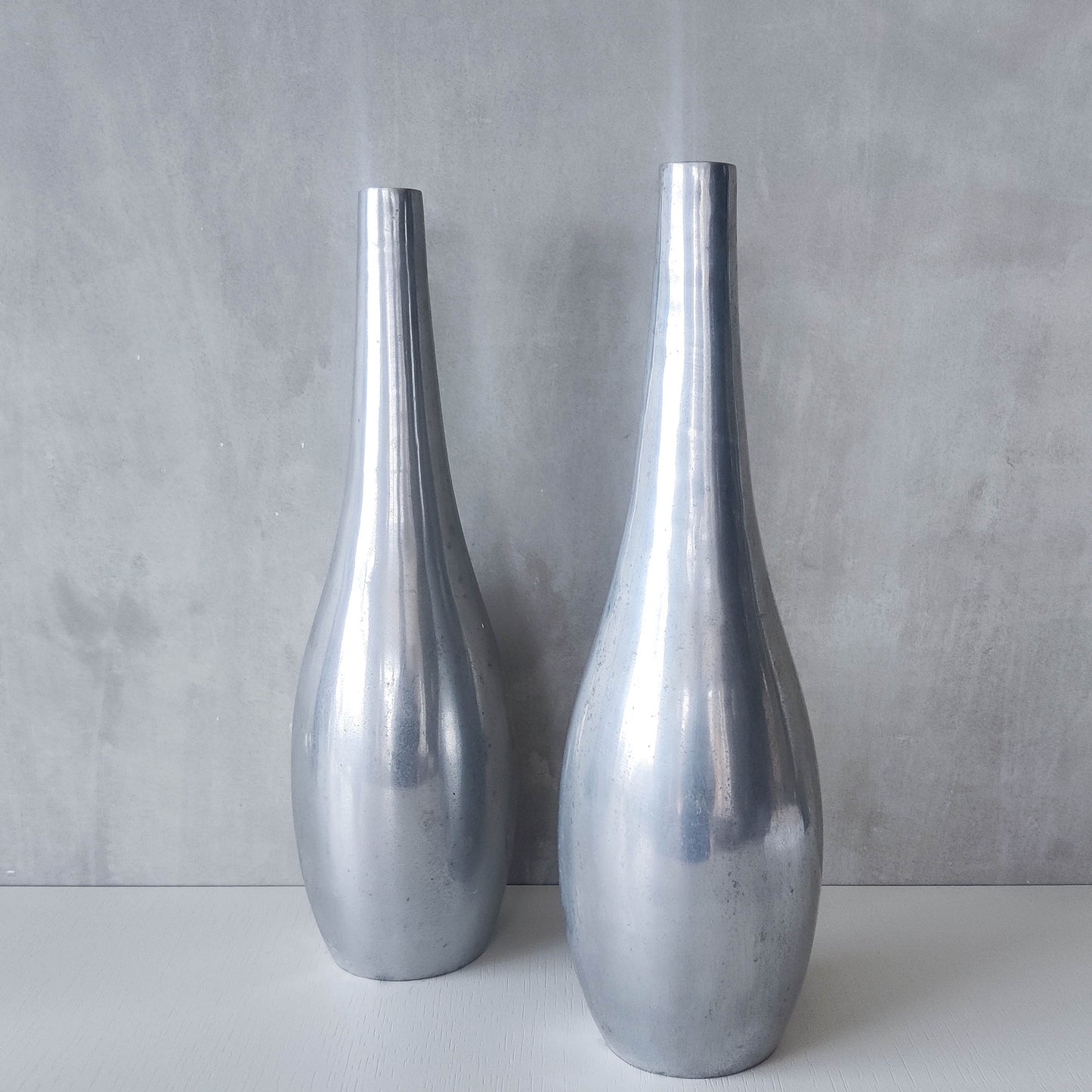 Pair of vintage cast aluminium modernist style sculptural bottles vases vessels 41cms