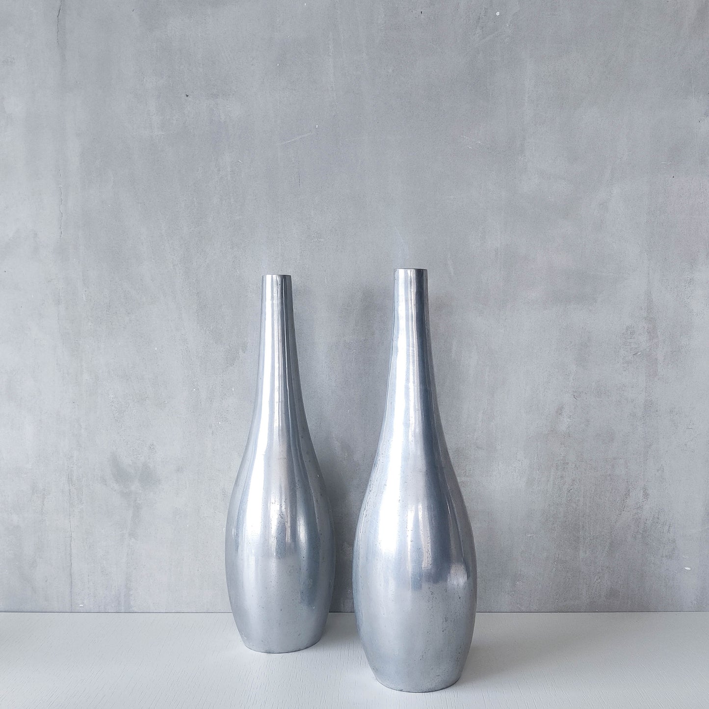 Pair of vintage cast aluminium modernist style sculptural bottles vases vessels 41cms
