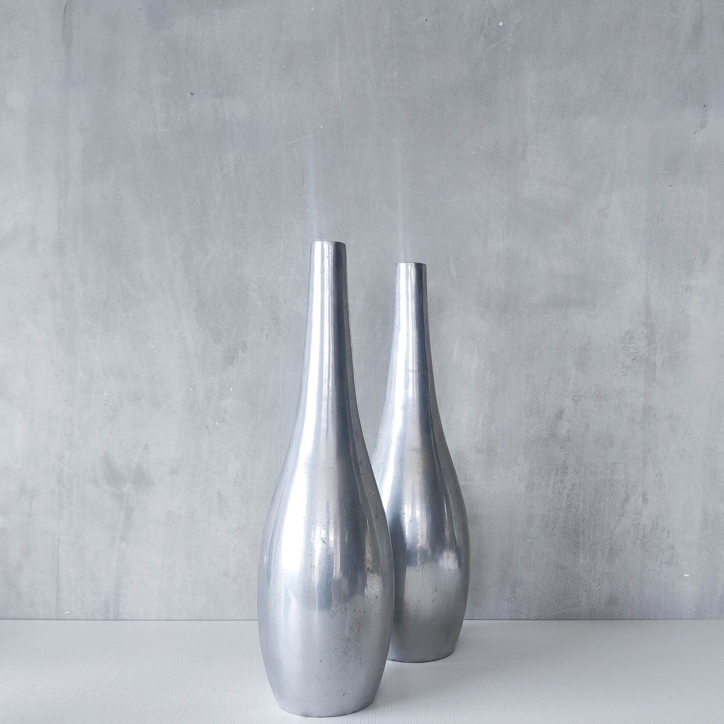 Pair of vintage cast aluminium modernist style sculptural bottles vases vessels 41cms