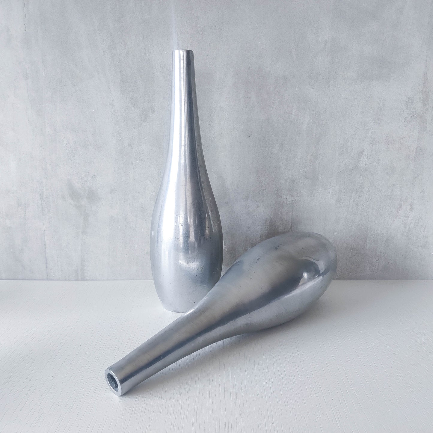 Pair of vintage cast aluminium modernist style sculptural bottles vases vessels 41cms