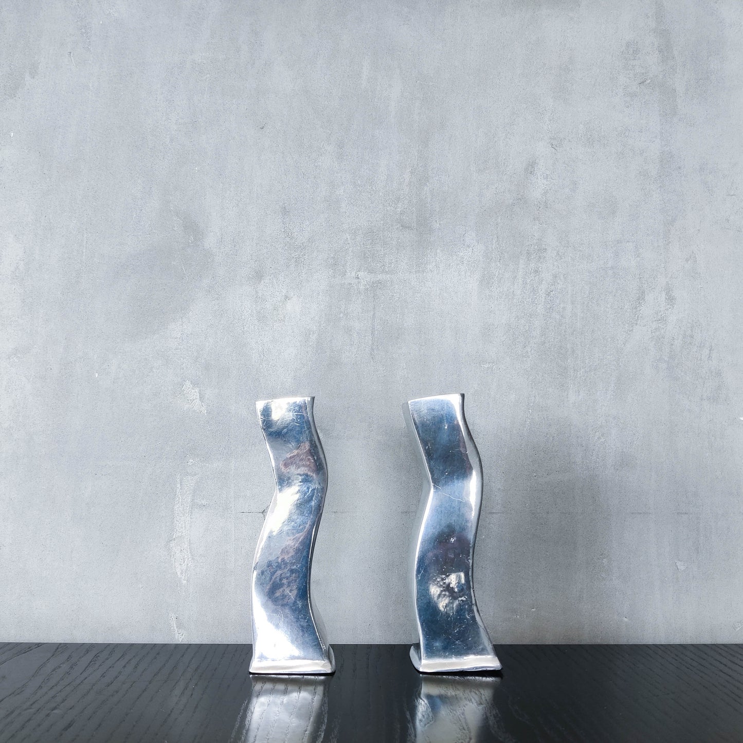 Pair of vintage cast aluminium 1990s modernist wavy wiggle sculptural candle holders