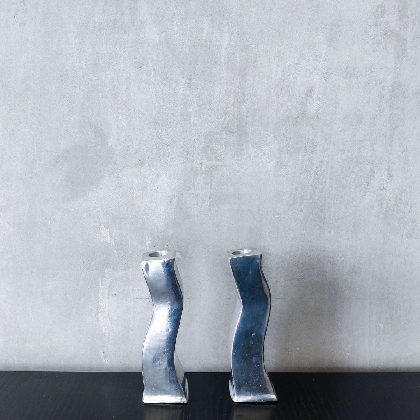 Pair of vintage cast aluminium 1990s modernist wavy wiggle sculptural candle holders