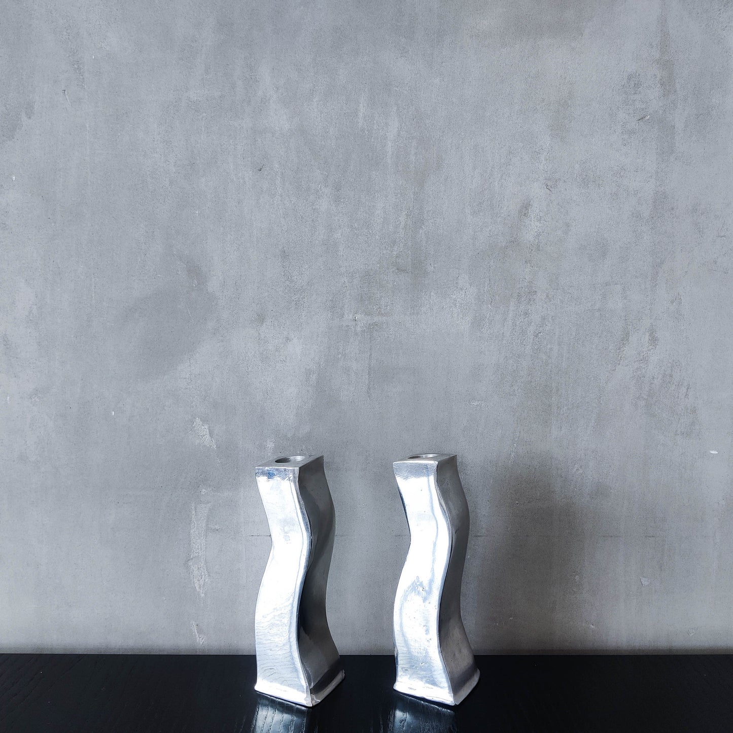 Pair of vintage cast aluminium 1990s modernist wavy wiggle sculptural candle holders