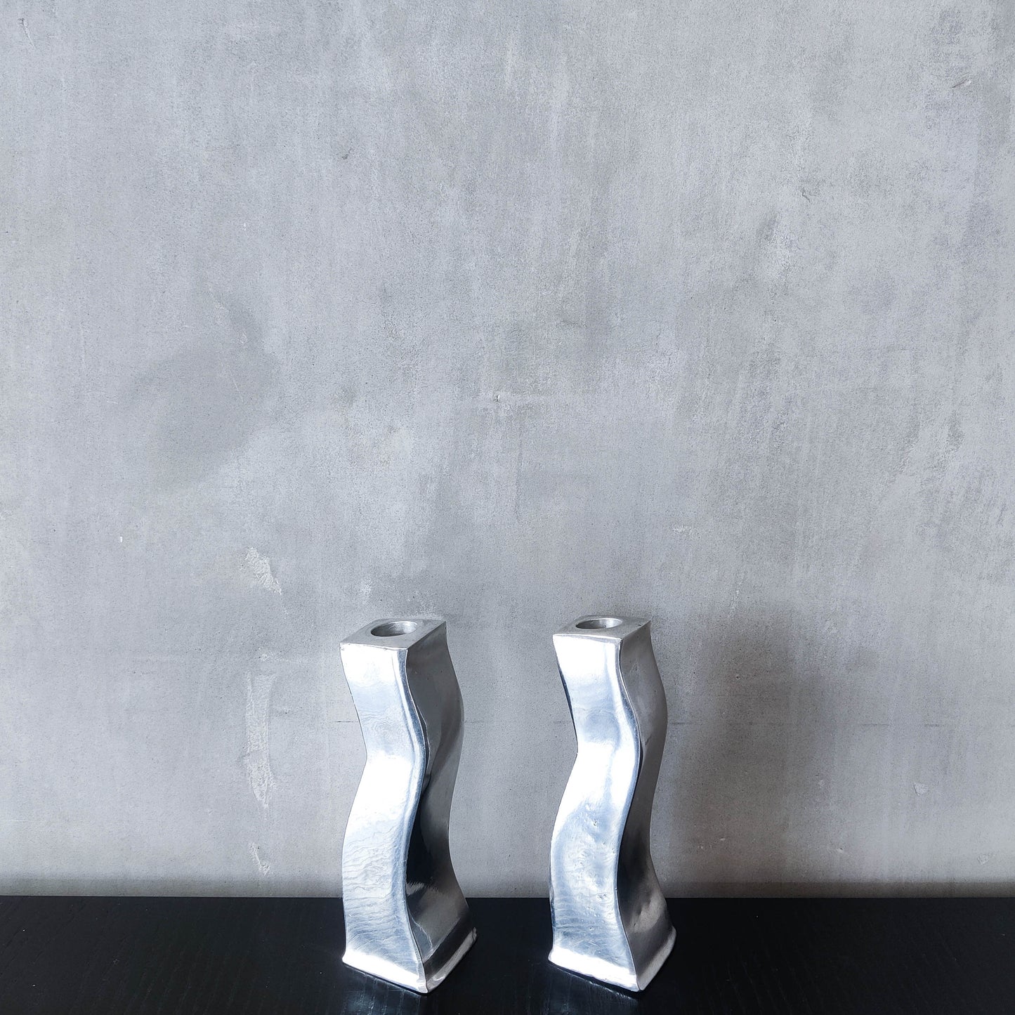 Pair of vintage cast aluminium 1990s modernist wavy wiggle sculptural candle holders