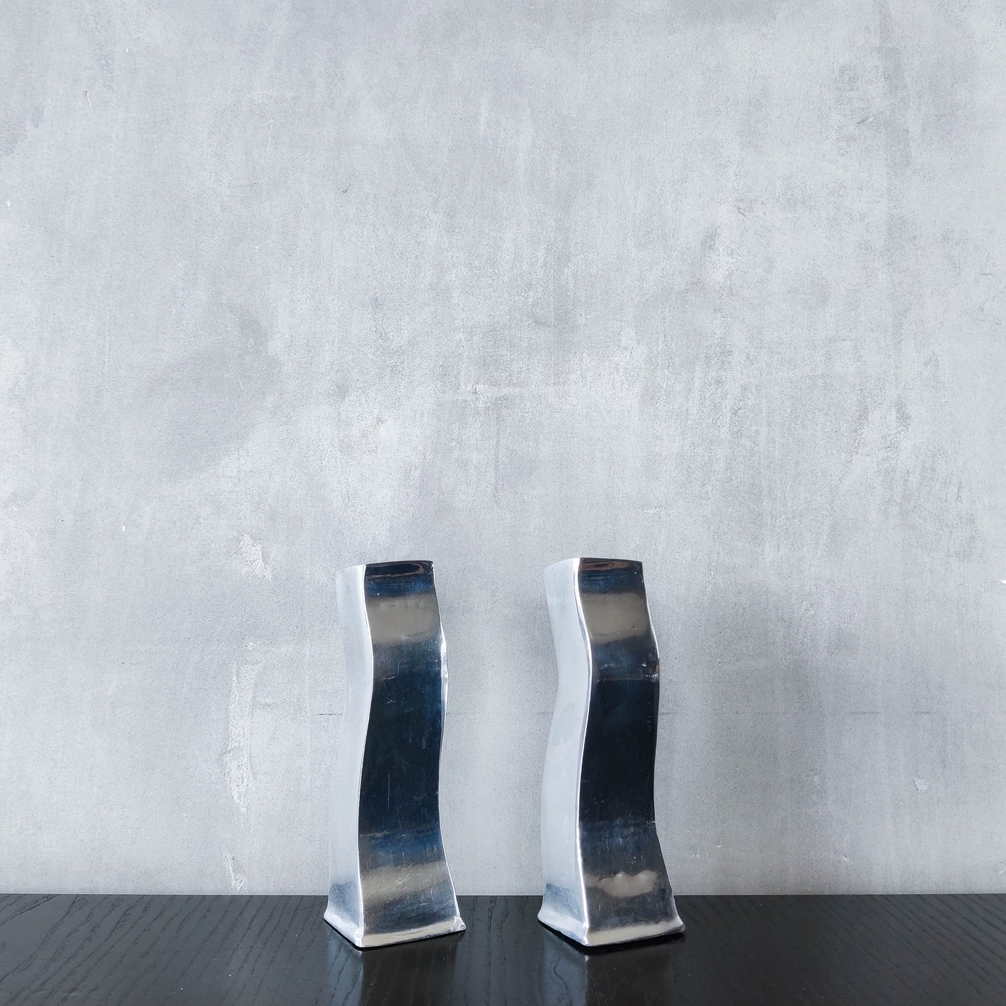 Pair of vintage cast aluminium 1990s modernist wavy wiggle sculptural candle holders