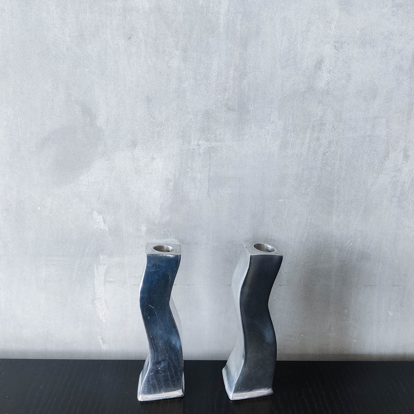 Pair of vintage cast aluminium 1990s modernist wavy wiggle sculptural candle holders
