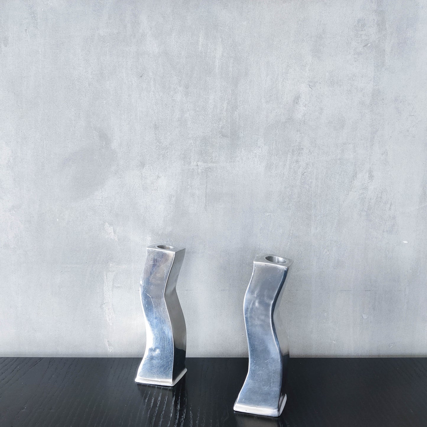 Pair of vintage cast aluminium 1990s modernist wavy wiggle sculptural candle holders