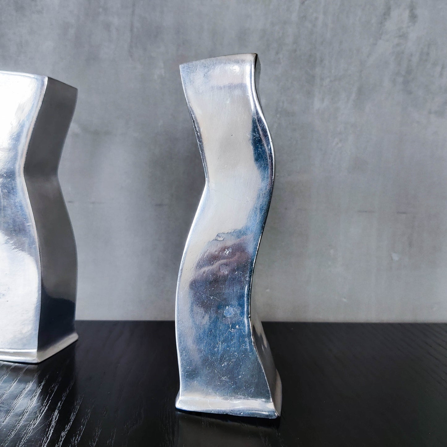 Pair of vintage cast aluminium 1990s modernist wavy wiggle sculptural candle holders