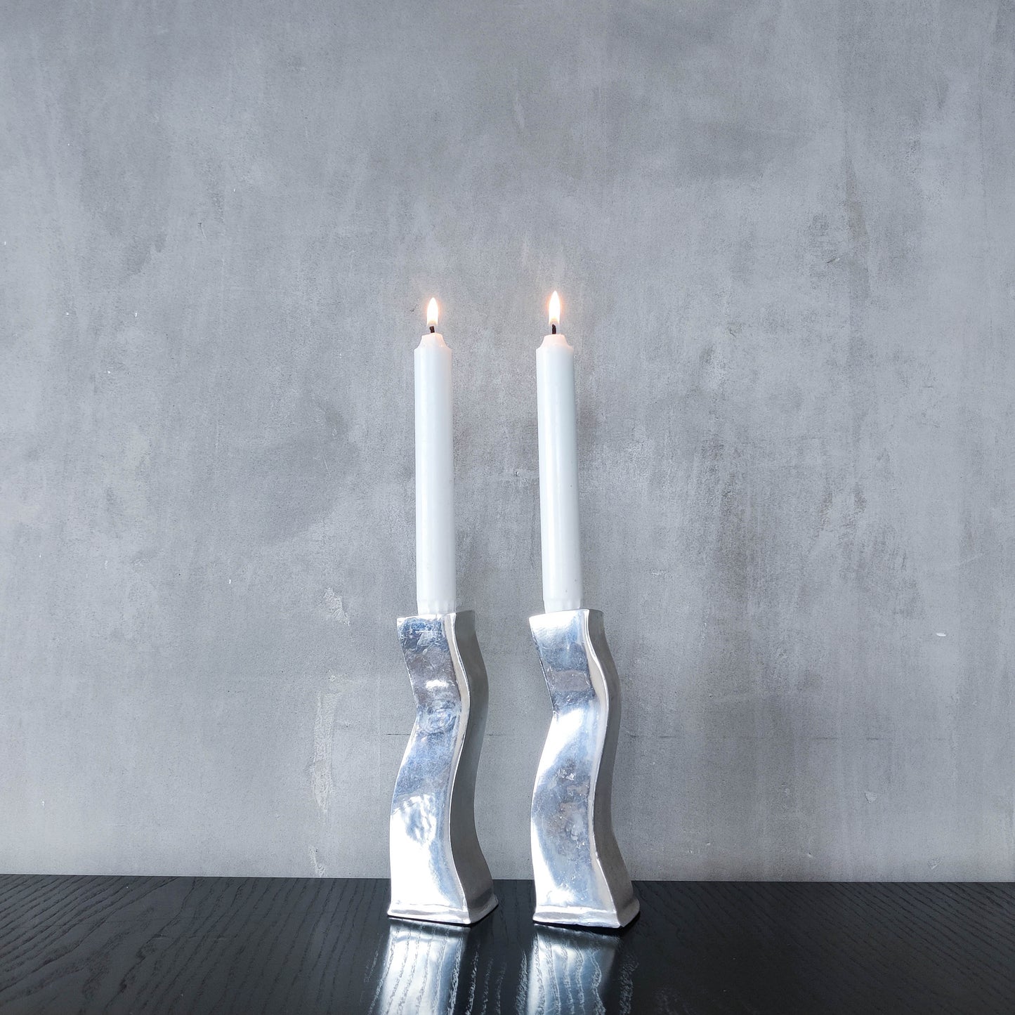 Pair of vintage cast aluminium 1990s modernist wavy wiggle sculptural candle holders