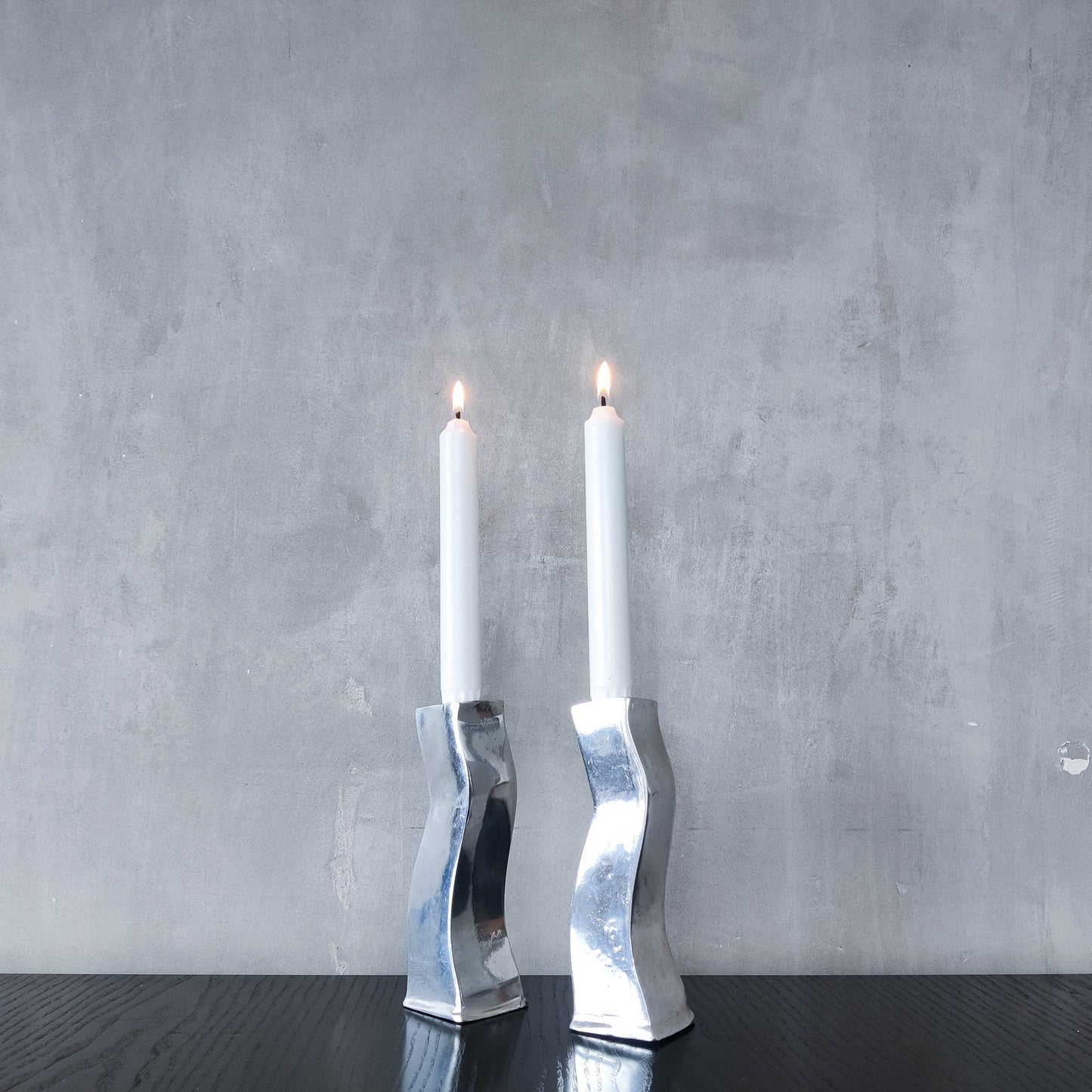 Pair of vintage cast aluminium 1990s modernist wavy wiggle sculptural candle holders