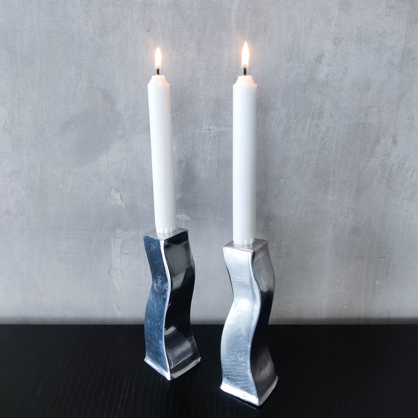 Pair of vintage cast aluminium 1990s modernist wavy wiggle sculptural candle holders