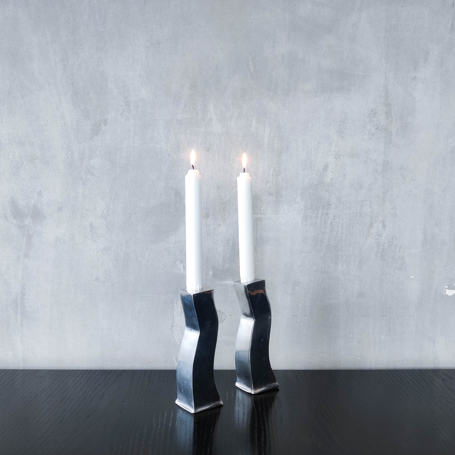 Pair of vintage cast aluminium 1990s modernist wavy wiggle sculptural candle holders
