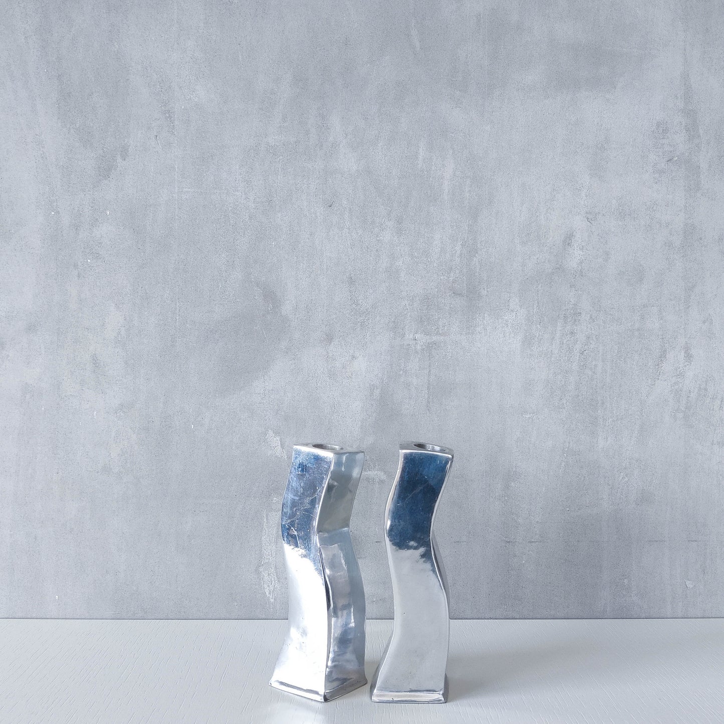 Pair of vintage cast aluminium 1990s modernist wavy wiggle sculptural candle holders
