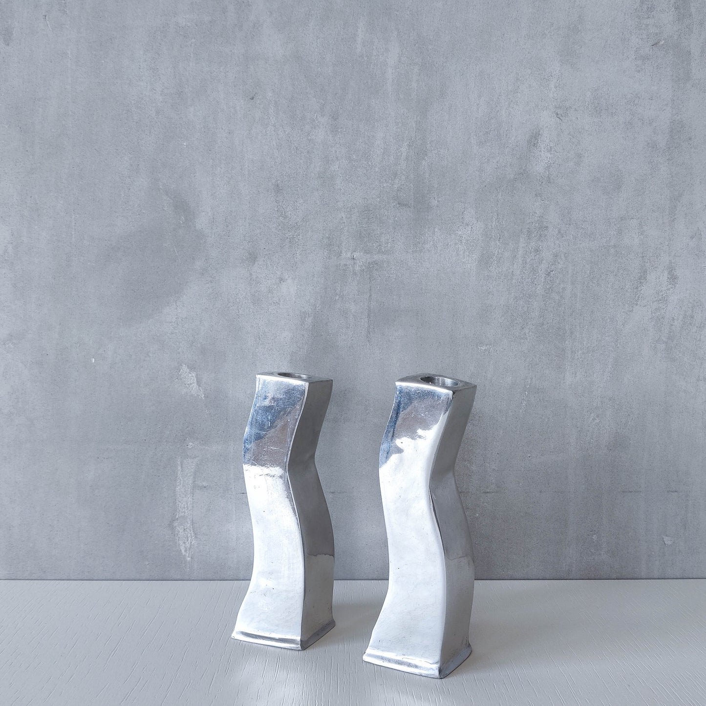 Pair of vintage cast aluminium 1990s modernist wavy wiggle sculptural candle holders
