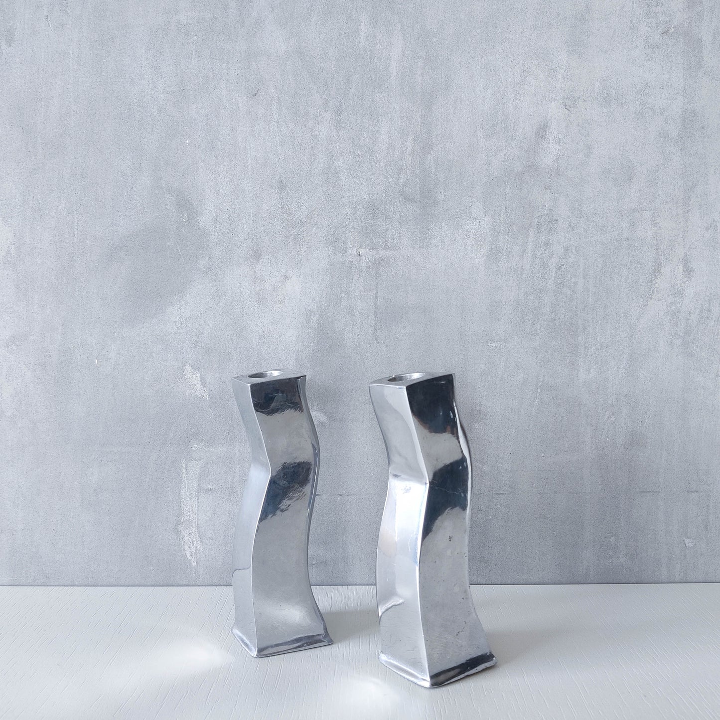 Pair of vintage cast aluminium 1990s modernist wavy wiggle sculptural candle holders