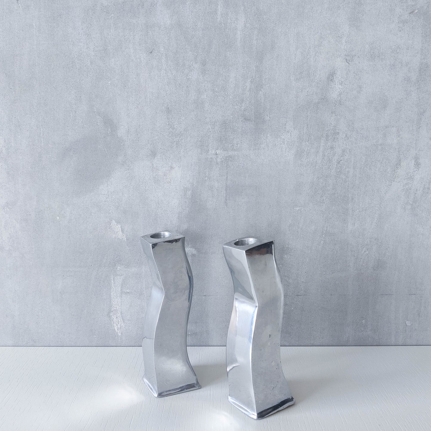 Pair of vintage cast aluminium 1990s modernist wavy wiggle sculptural candle holders