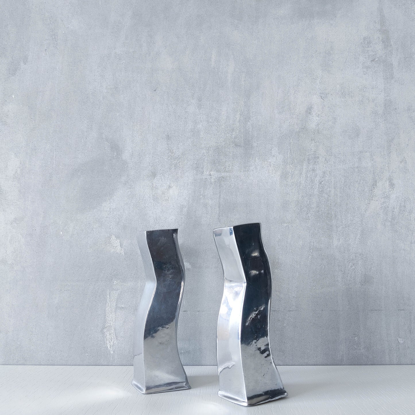 Pair of vintage cast aluminium 1990s modernist wavy wiggle sculptural candle holders