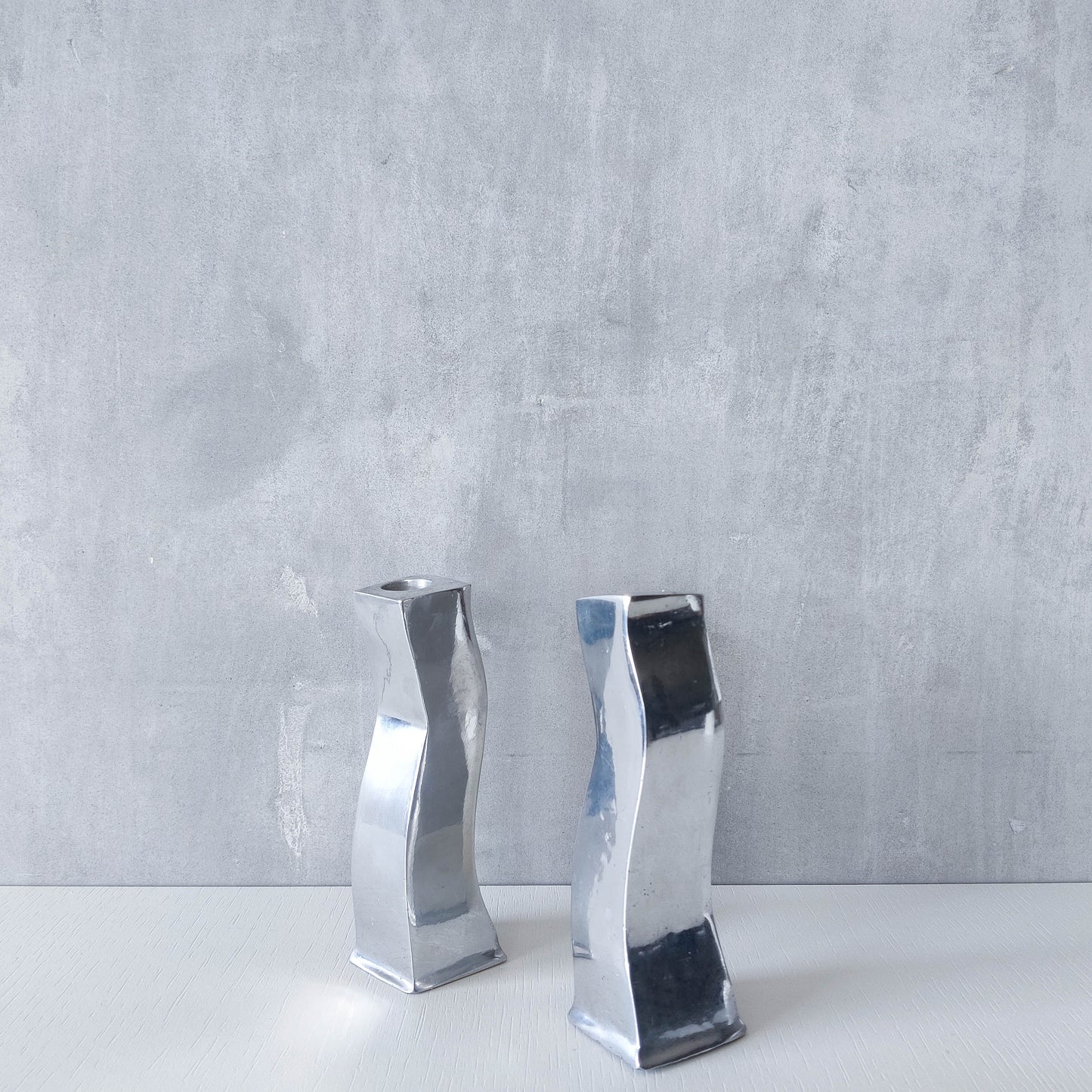 Pair of vintage cast aluminium 1990s modernist wavy wiggle sculptural candle holders