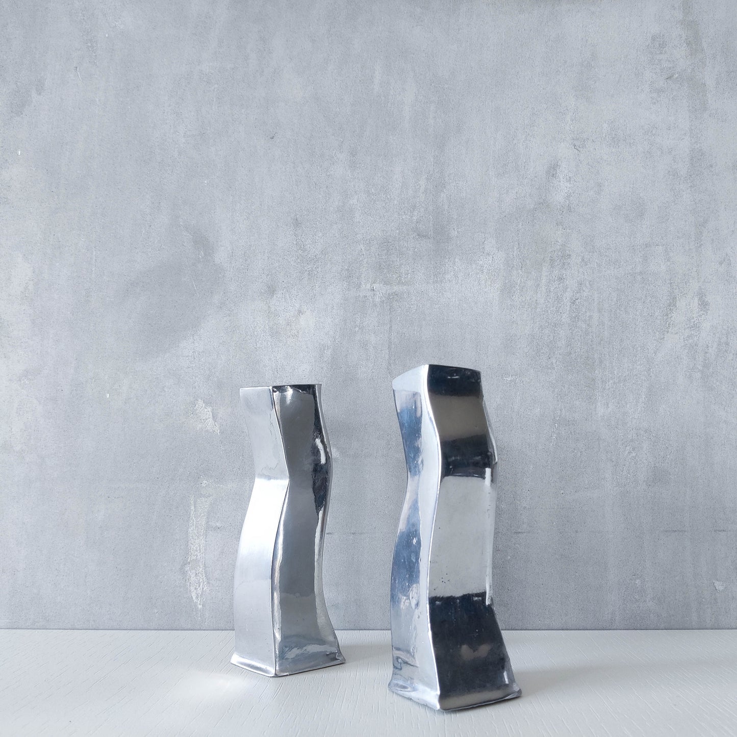 Pair of vintage cast aluminium 1990s modernist wavy wiggle sculptural candle holders