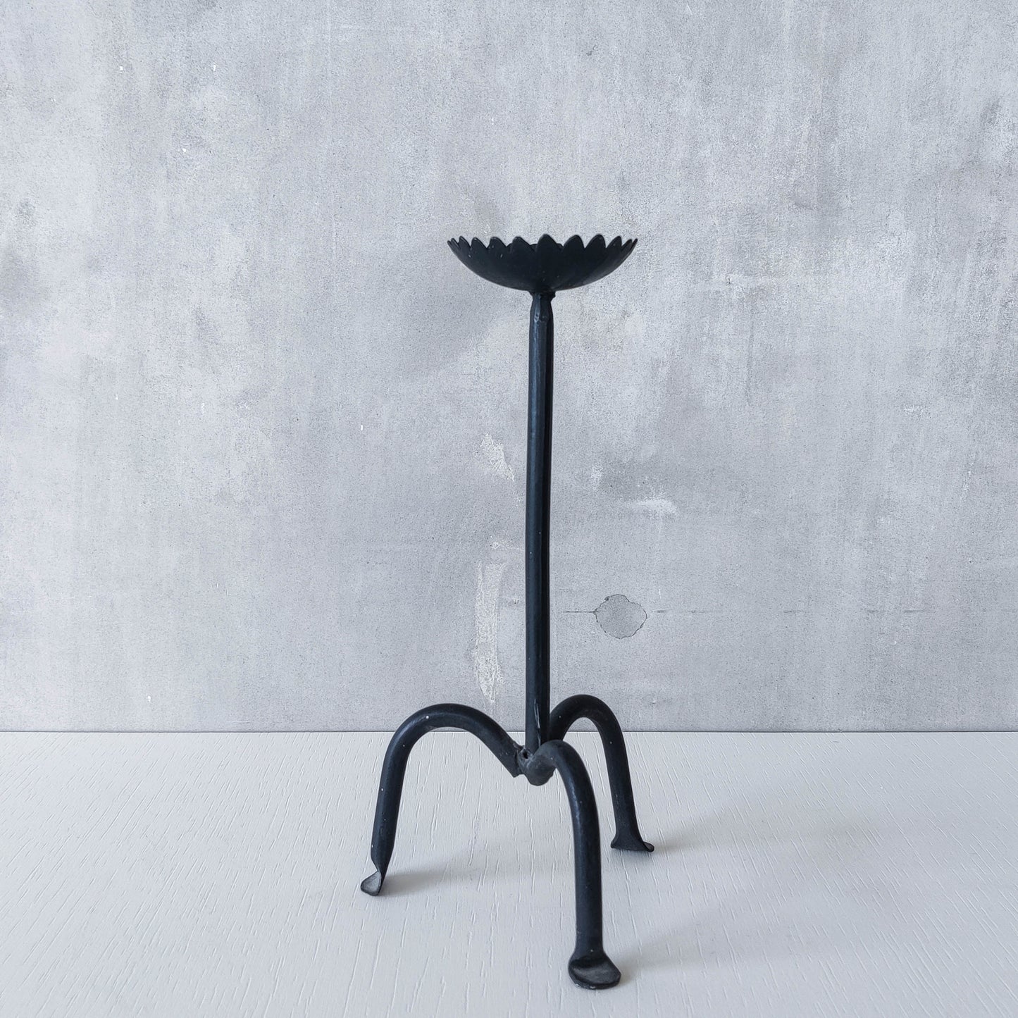 Hand forged black iron sculptural candle holder with scalloped edge tripod feet