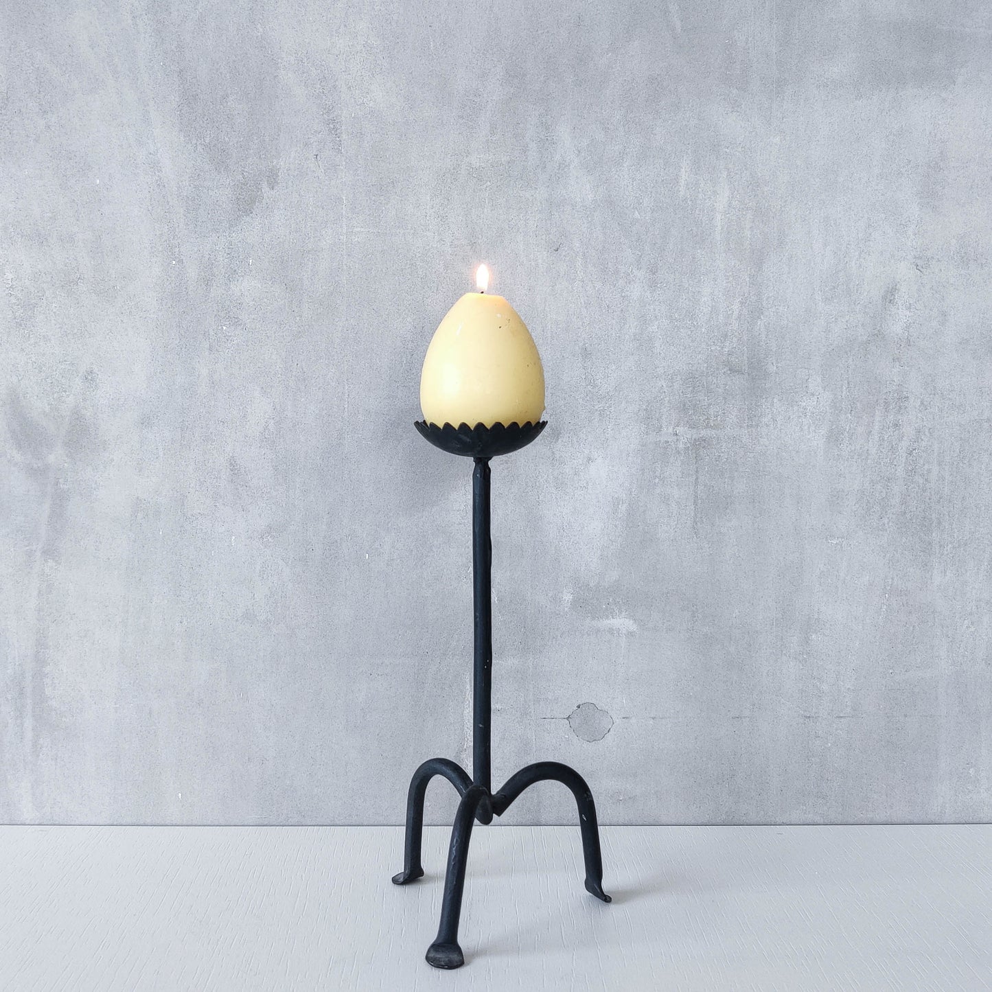 Hand forged black iron sculptural candle holder with scalloped edge tripod feet