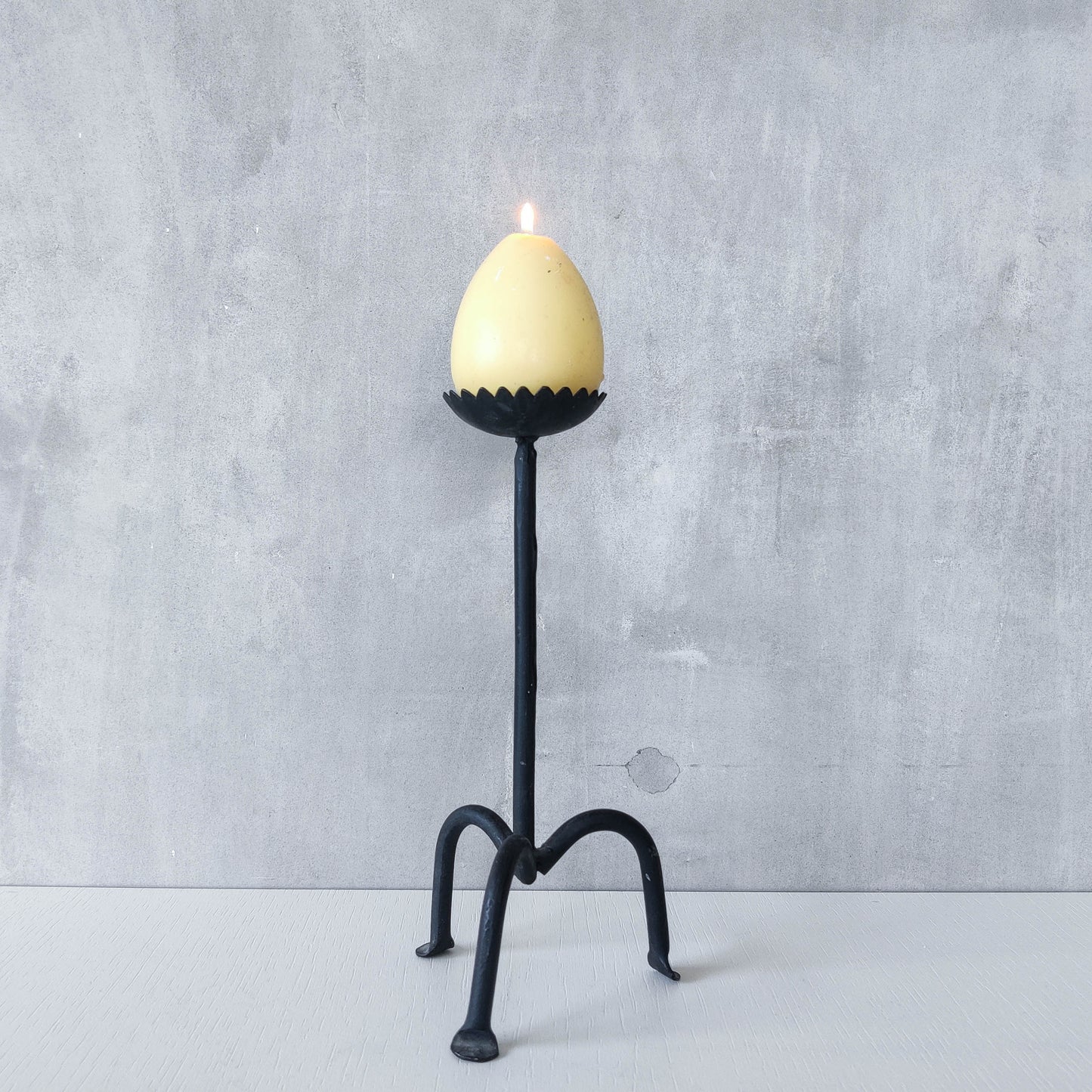 Hand forged black iron sculptural candle holder with scalloped edge tripod feet