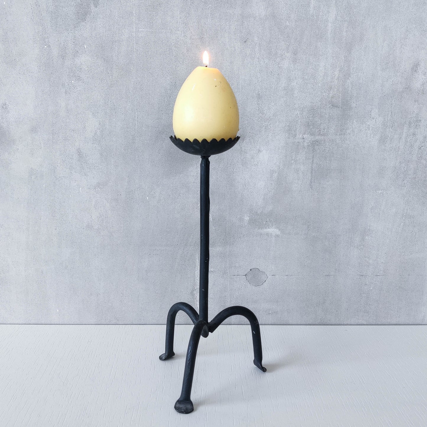 Hand forged black iron sculptural candle holder with scalloped edge tripod feet