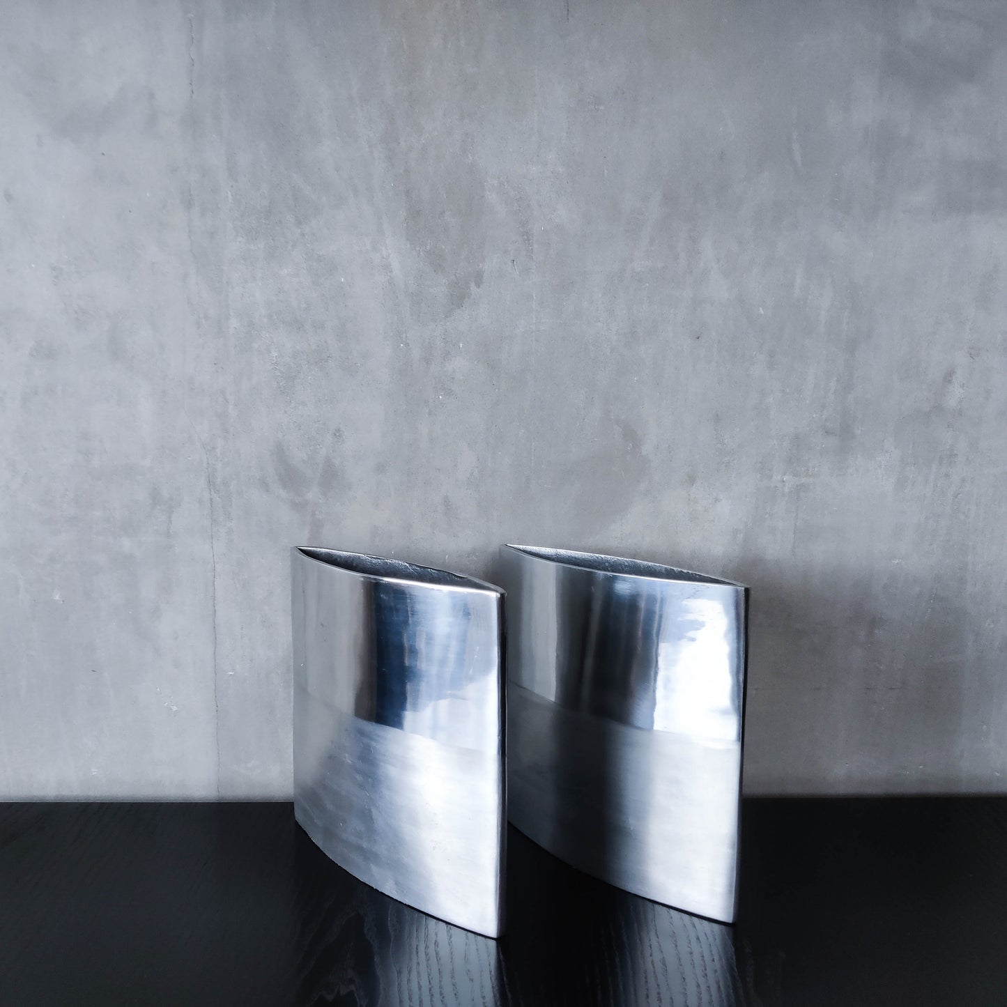 Pair of vintage 00s flat sculptural hand cast aluminium vases