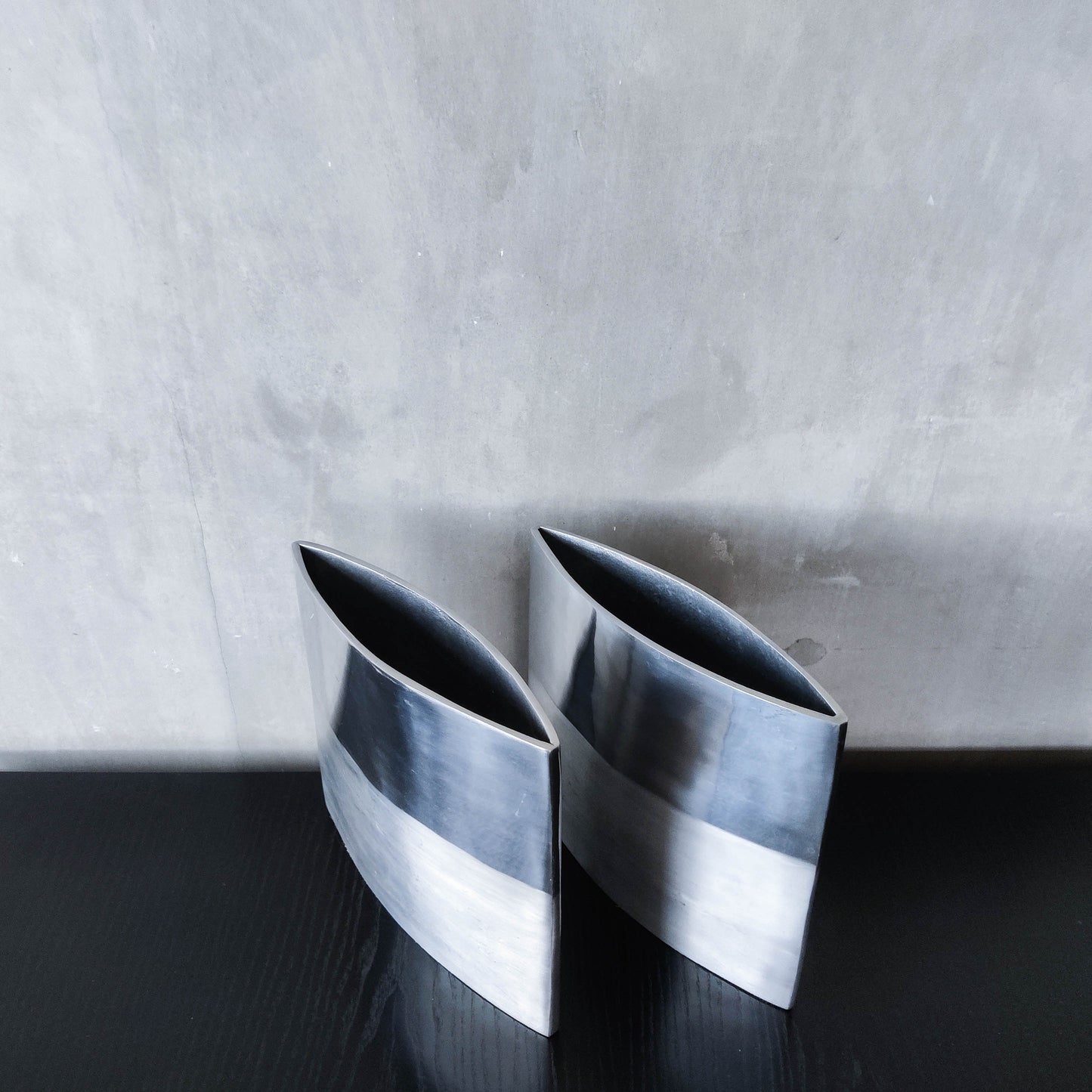 Pair of vintage 00s flat sculptural hand cast aluminium vases