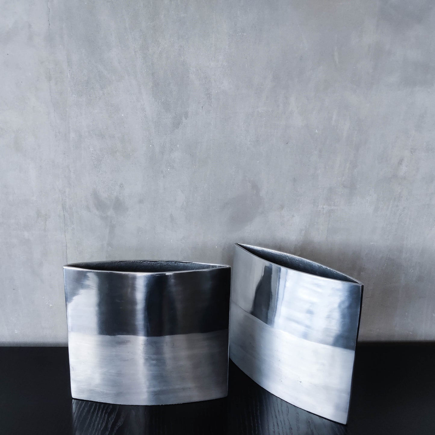 Pair of vintage 00s flat sculptural hand cast aluminium vases