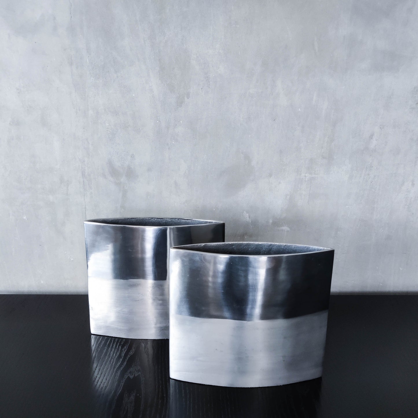 Pair of vintage 00s flat sculptural hand cast aluminium vases