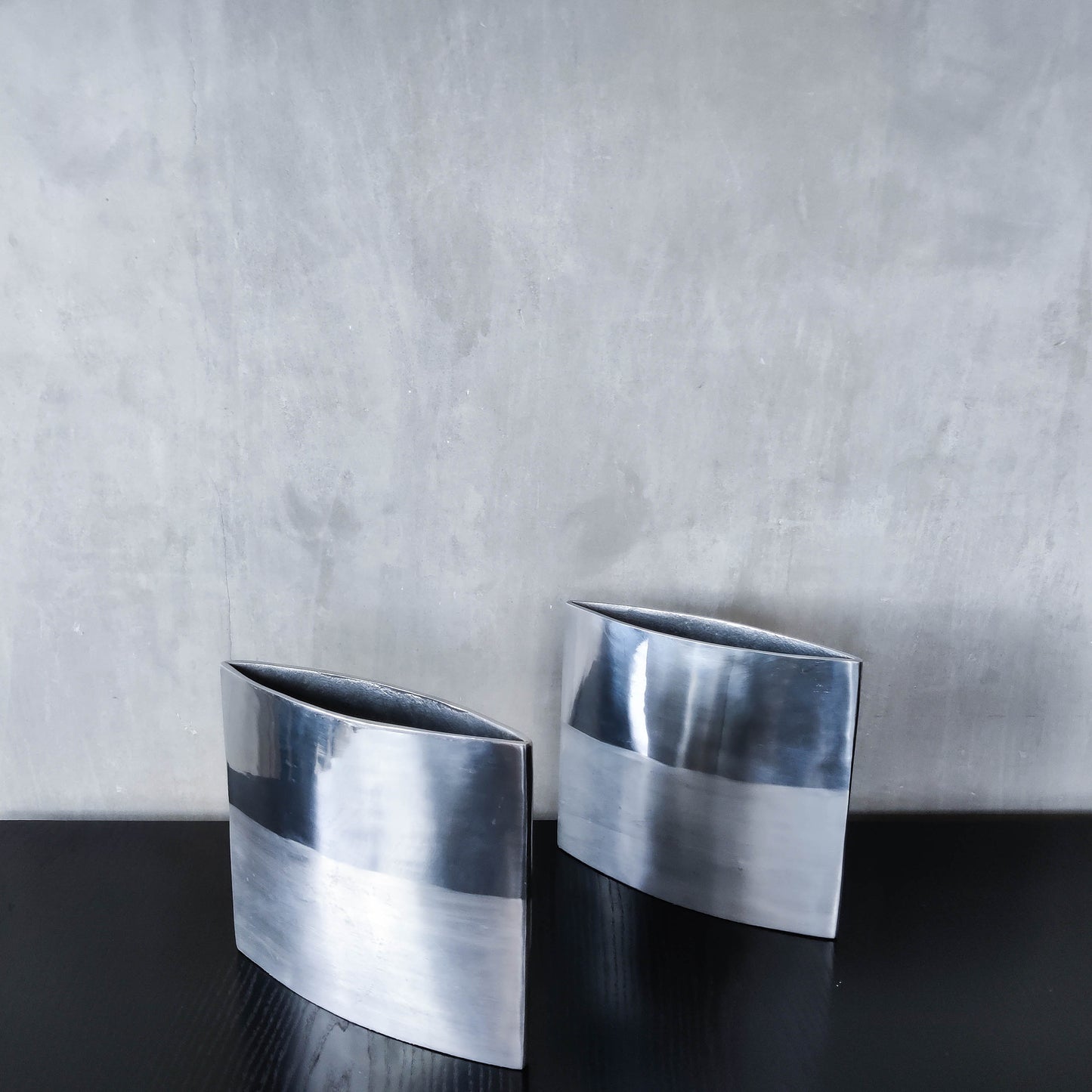 Pair of vintage 00s flat sculptural hand cast aluminium vases