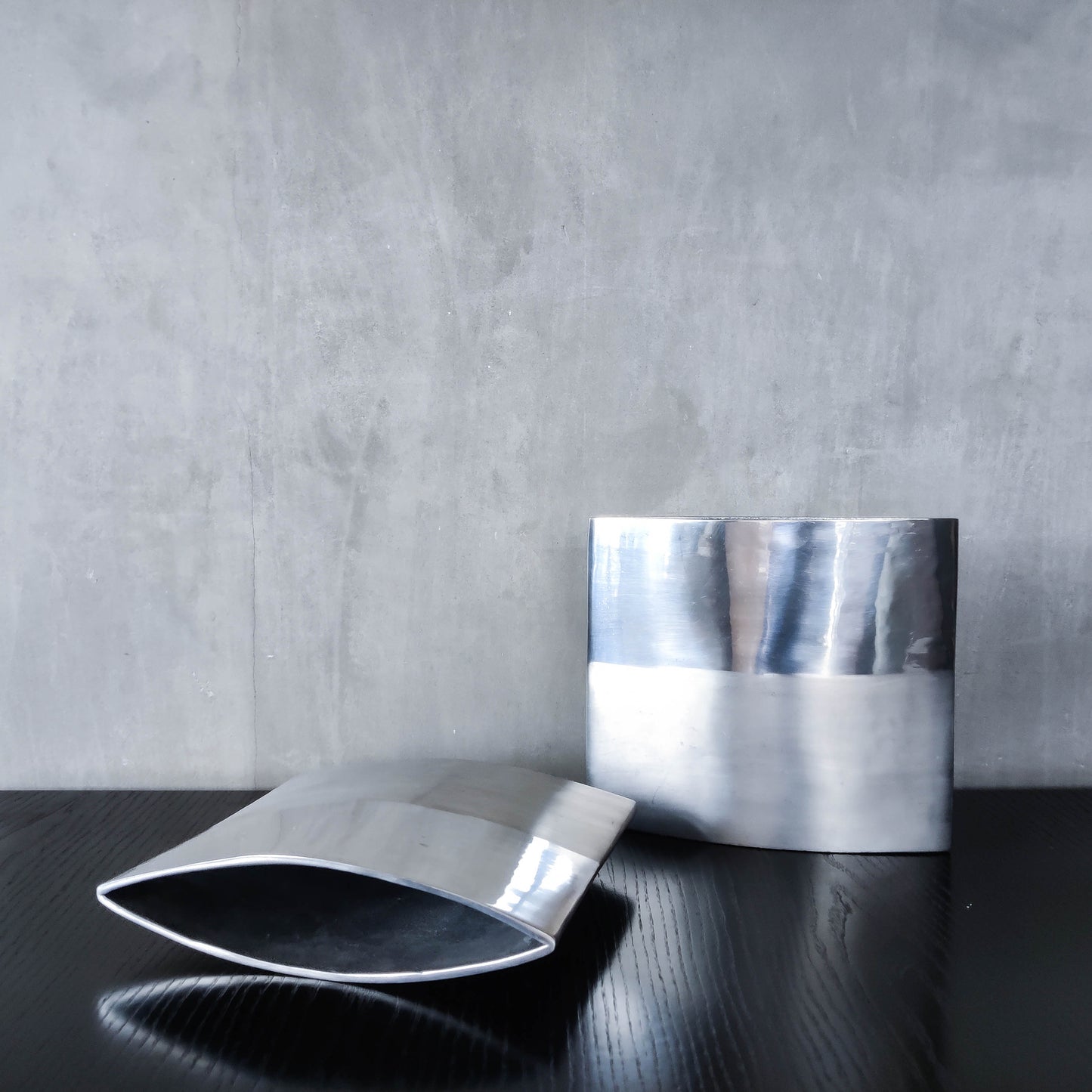 Pair of vintage 00s flat sculptural hand cast aluminium vases